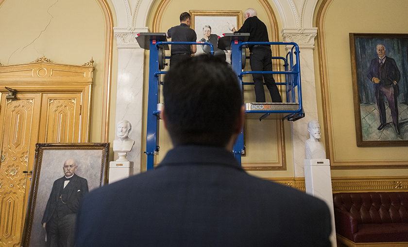 The President of the Storting watching the mounting of the two women’s portraits in the Eidsvoll Gallery.